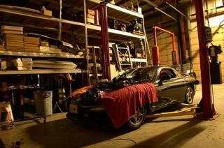 A Mazda RX-7 in an auto shop